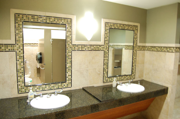 Restroom at Highland Oaks Church: two mirrors framed in mosaic over a dark stone counter