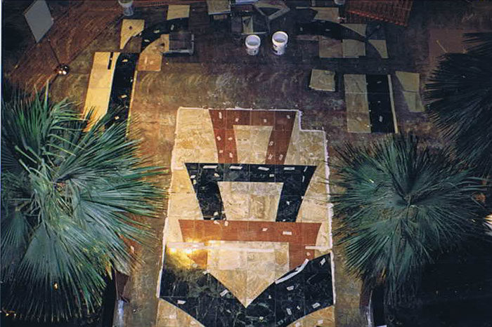 Stone floor medallion at Hollywood Casino seen from above, dark and light inlay in a pointed pattern