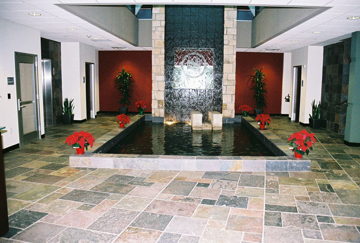 Lobby at Irving Municipal Complex: a slate floor in front of a stone water wall