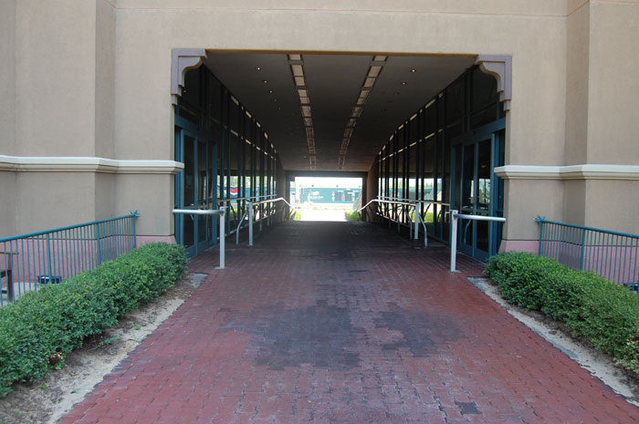 Paved walkway through a tunnel at Lone Star Park, opening to daylight at the far end