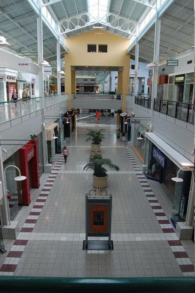 Concourse at Parks Mall with a patterned tile border under a skylit roof