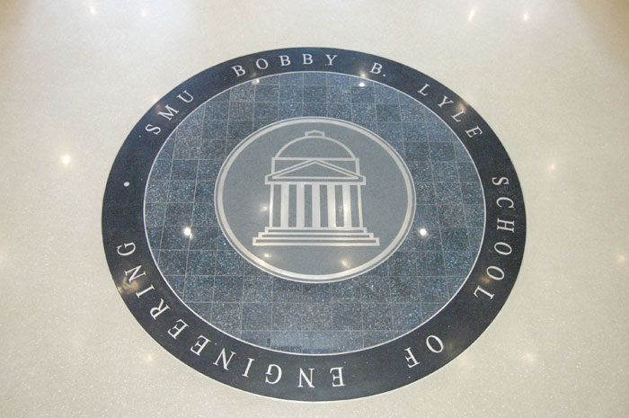 Circular school seal set into the floor at SMU Caruth Hall