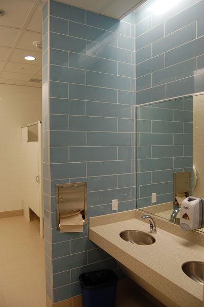 Restroom at Texas Woman's University Stroke Center with blue wall tile above a counter